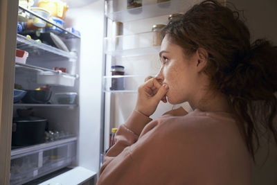 Side view of young woman looking away