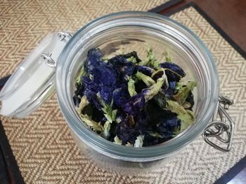 High angle view of purple flowers in jar on table