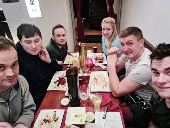 Group of friends sitting on table