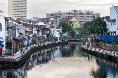 Bridge over canal amidst buildings in city