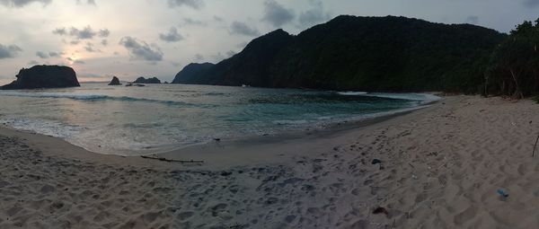 Scenic view of beach against sky during sunset