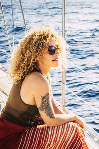 Portrait of young woman sitting on boat in sea