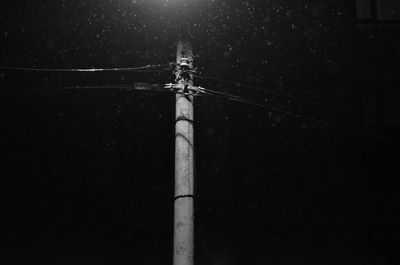 Low angle view of telephone pole against sky