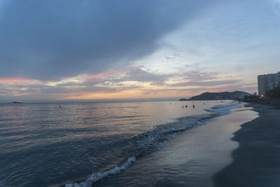 Scenic view of beach against sky during sunset