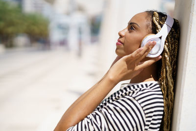 Side view of woman listening music