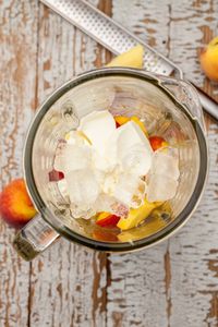 High angle view of fruits and ice cubes in blender