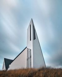 Low angle view of built structure on field against sky