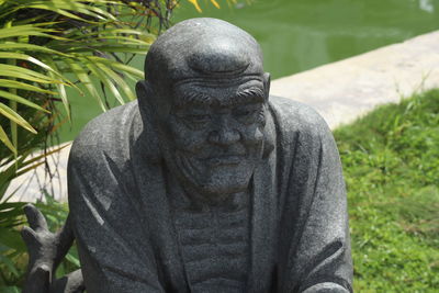Close-up of statue against plants in garden