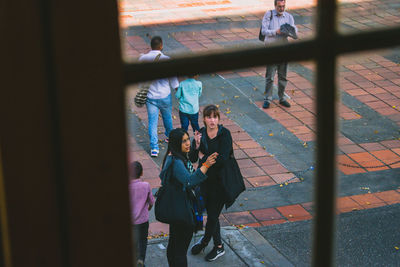 High angle view of people standing on footpath