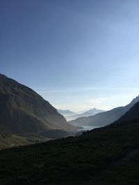 Scenic view of mountains against blue sky