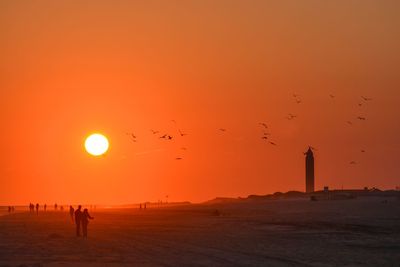 Scenic view of beach against sky during sunset