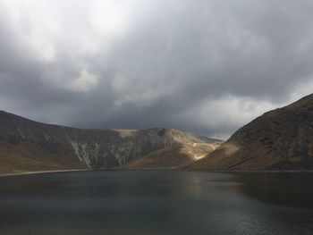 Scenic view of mountains against cloudy sky