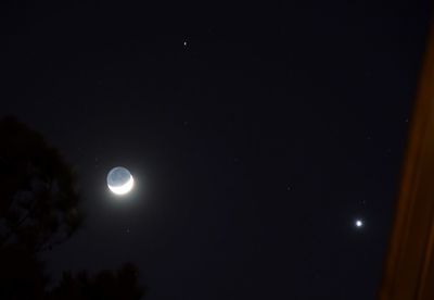 Low angle view of moon against sky at night