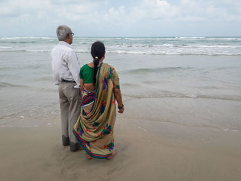 Rear view of man standing on beach