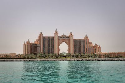 Buildings in city against clear sky