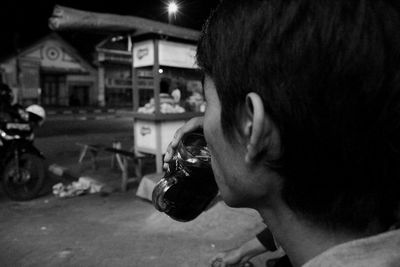 Side view of man having coffee at street