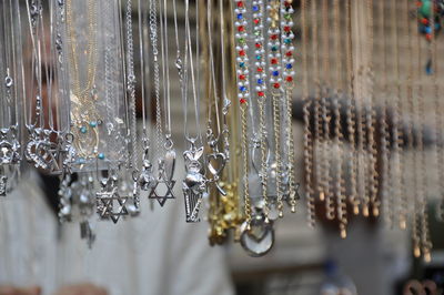Close-up of jewelry hanging on market stall