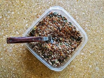 Directly above shot of seeds in plastic container