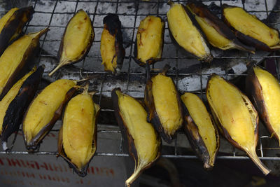 High angle view of yellow bananas on barbecue grill