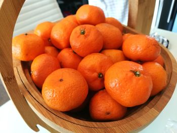 Close-up of oranges in basket on table