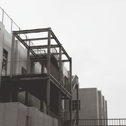 Low angle view of staircase by building against sky