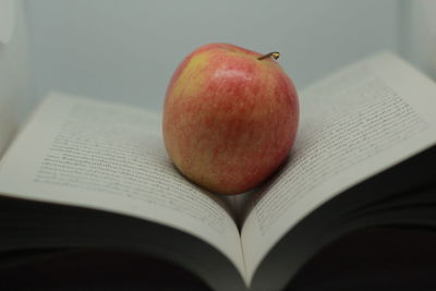 Close-up of apple on book