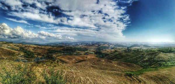 Scenic view of mountains against cloudy sky