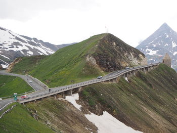 Scenic view of bridge over mountains against sky