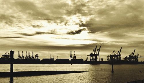 View of harbor against cloudy sky