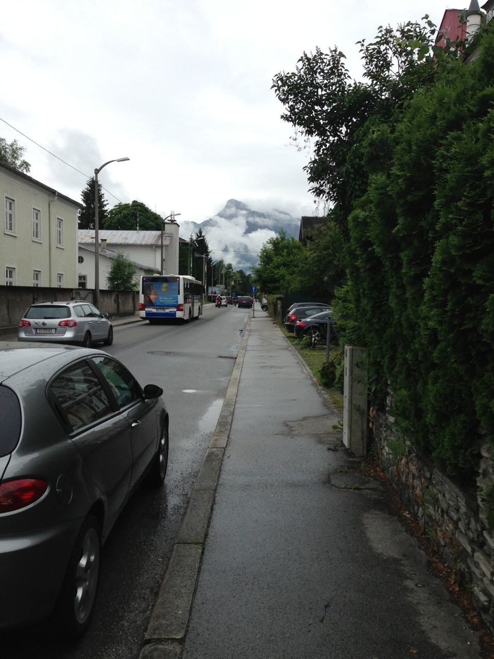 transportation, car, land vehicle, mode of transport, road, street, the way forward, sky, building exterior, diminishing perspective, architecture, tree, built structure, vanishing point, travel, stationary, parked, day, on the move, vehicle