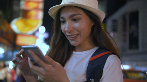 Portrait of young woman using mobile phone