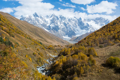 Scenic view of mountains against cloudy sly
