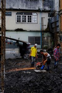 Men working while standing outdoors