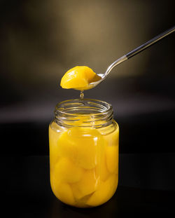 Close-up of canned peaches in jar