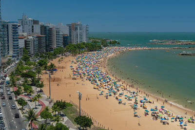 High angle view of buildings by sea against sky