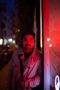 Portrait of young man standing in city