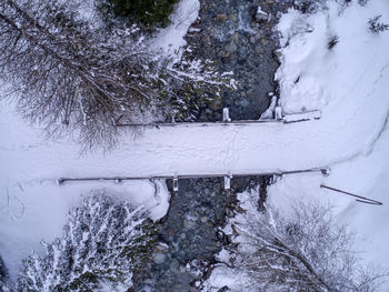 Directly above shot of snow covered bridge over river during winter