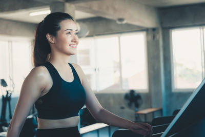 Smiling woman exercising in gym