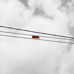 Low angle view of telephone pole against sky