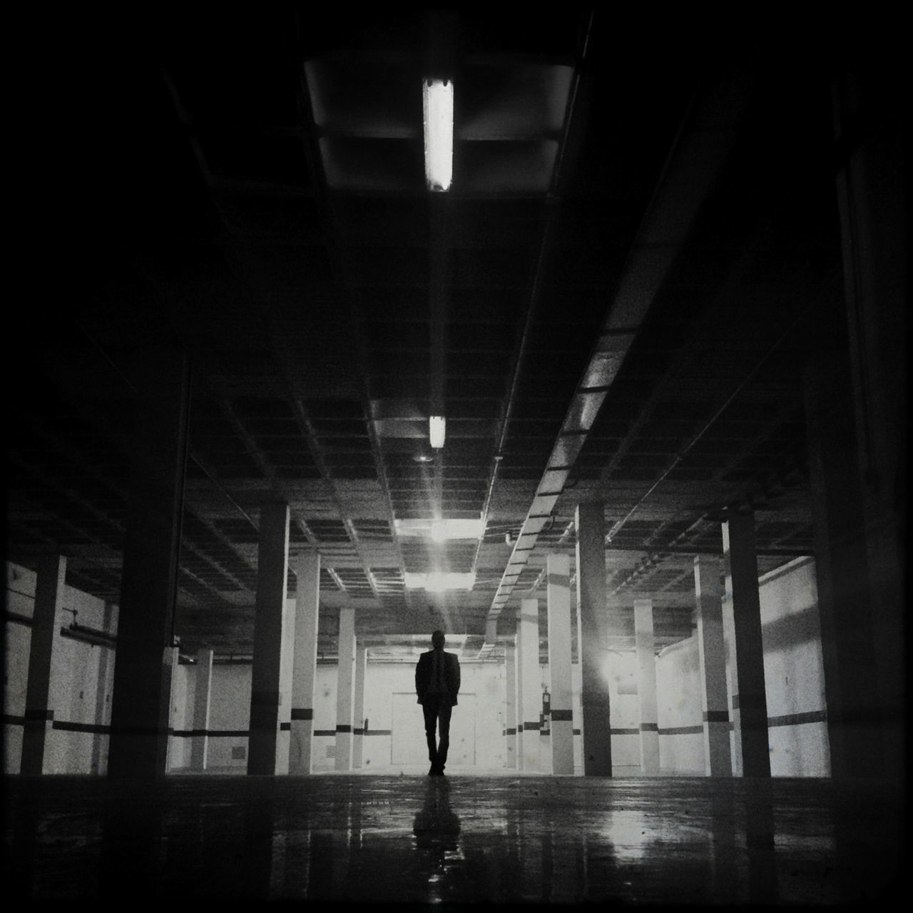 indoors, architecture, built structure, illuminated, ceiling, lighting equipment, full length, reflection, corridor, walking, silhouette, lifestyles, men, building, night, standing, rear view, glass - material