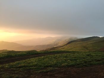 Scenic view of field against sky during sunset