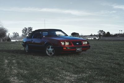 Car on field against sky