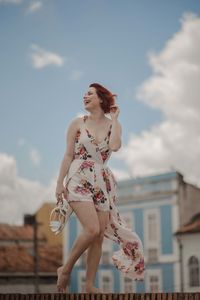 Low angle view of woman against sky