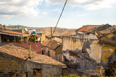 Houses in town against sky