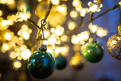 Close-up of illuminated christmas lights hanging on tree