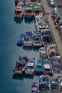 High angle view of fishing boats moored at harbor