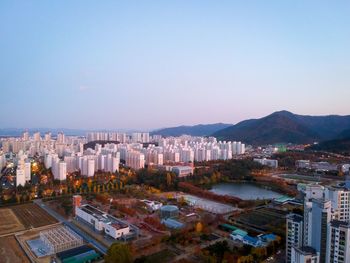 High angle view of buildings in city against clear sky