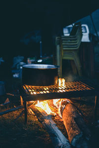 View of cooking utensil on flame outdoors