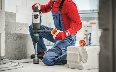 Low section of man working at construction site