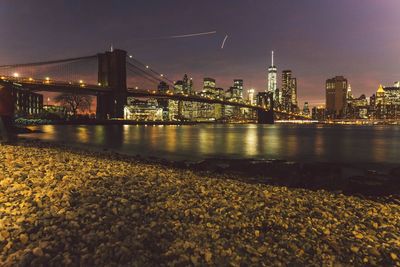 Suspension bridge over river at night